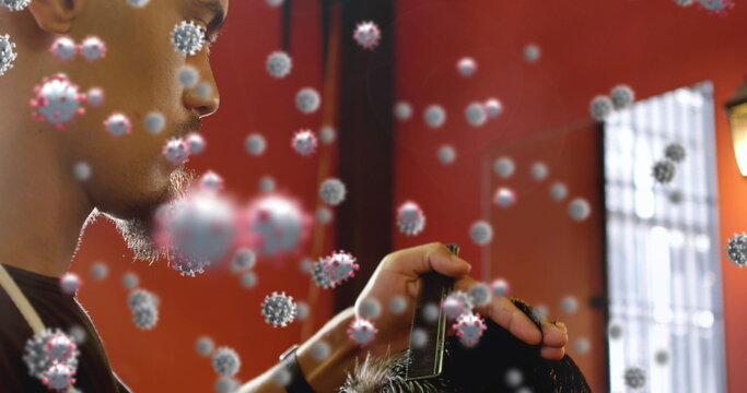 Barber cutting hair while surrounded by floating virus particles indoors