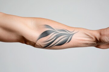 close-up shot of sleek black and white tattoo on person arm focusing on intricate details and smooth linework