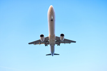 Large passenger plane flying in the blue sky