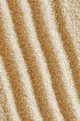 Aesthetic minimal natural sand background with sandy waves and ripples, light and shadows. Pastel colored zen garden fon for Spa, meditation, relaxation, wellness. Styled design photo, vertical