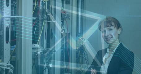 Image of digital envelope icon over woman in tech room with computer servers