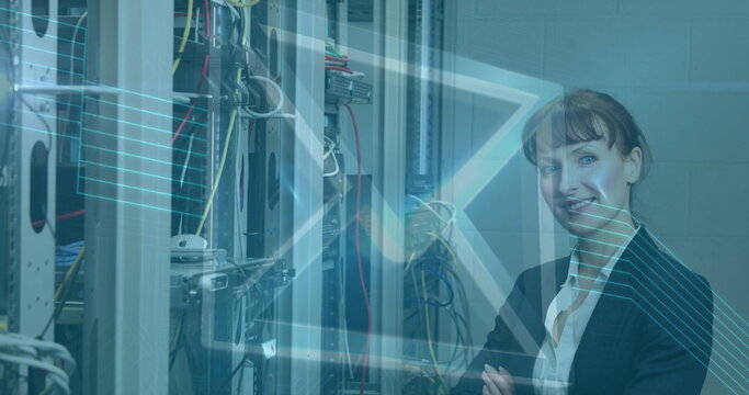 Image of digital envelope icon over woman in tech room with computer servers