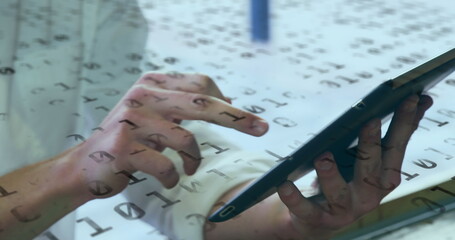 Image of binary coding numbers changing over woman using tablet