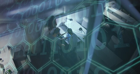 Image of binary coding and hexagons over team of people using laptop