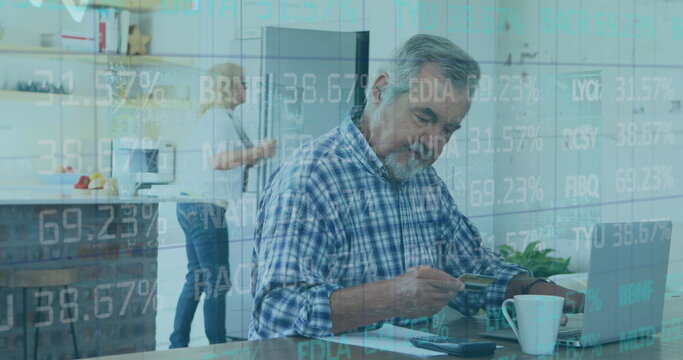 Image of financial data processing over senior man paying online using laptop - Powered by Adobe