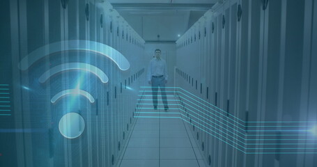 Image of wifi icon over caucasian man working in a server room
