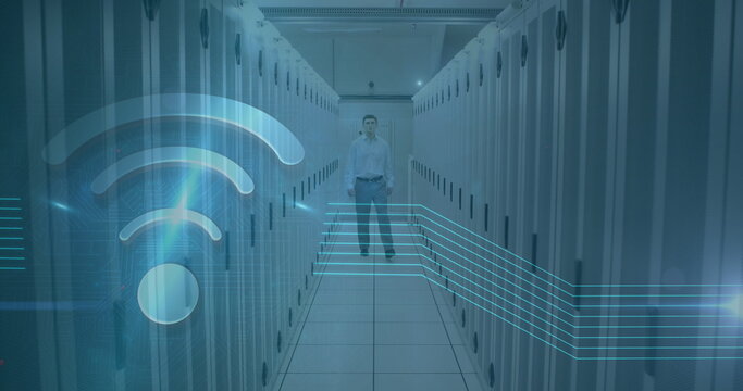 Image of wifi icon over caucasian man working in a server room