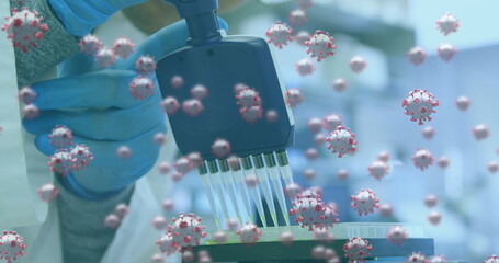 Image of covid cells with hands of scientist testing with equipment in lab
