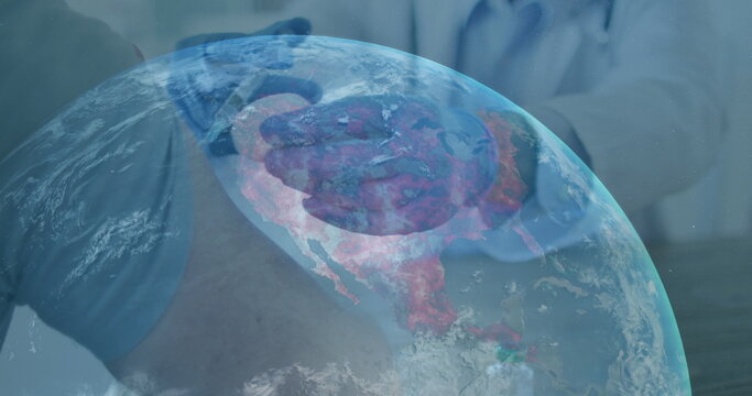 Image of globe with midsection of doctor giving vaccination to patient