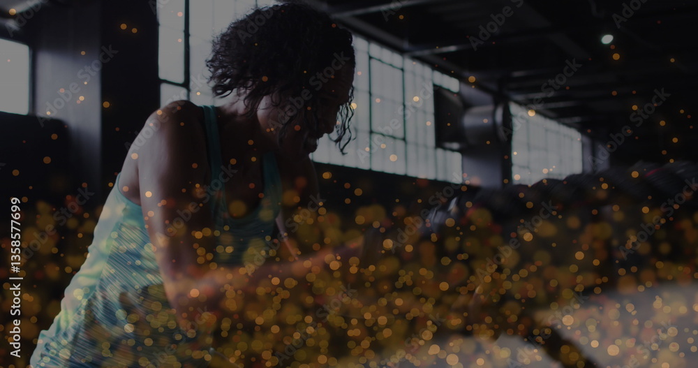 Poster image of golden dots floating over woman exercising with ropes in an abandoned building