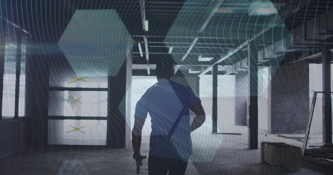 Digital composite image of hexagonal shapes against rear view of african american man running
