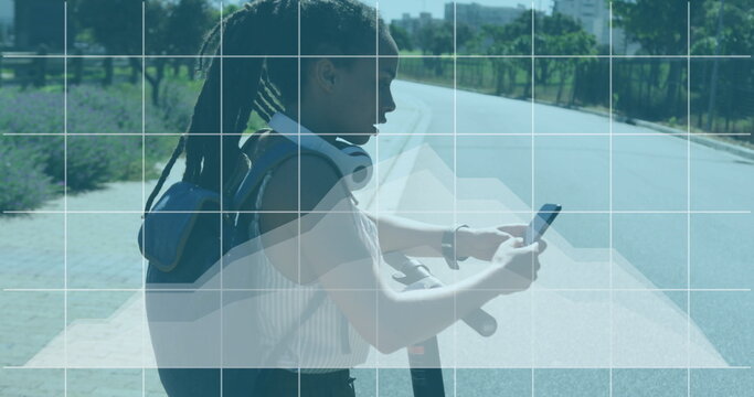 Statistical data processing against african american woman using smartphone on the street