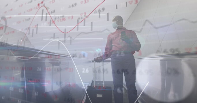 Financial data processing against man wearing face mask with trolley bag using smartphone - Powered by Adobe