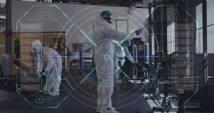 Digital interface against team of health workers spraying disinfectant at gym - Powered by Adobe