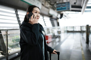 Fototapeta premium A Young Woman Engaged in Conversation While Traveling in an Urban Environment