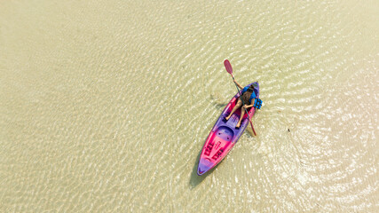 Aerial view of a kayak in the blue sea .man kayaking he does water sports activities.	