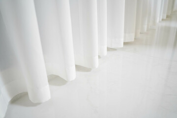 White curtains and marble tiles floor