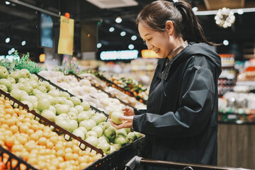 Joyful Woman Shopping for Fresh Fruits in Supermarket