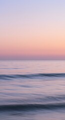 Blurry Ocean Horizon with Soft Waves and a Pastel Sunrise Sky