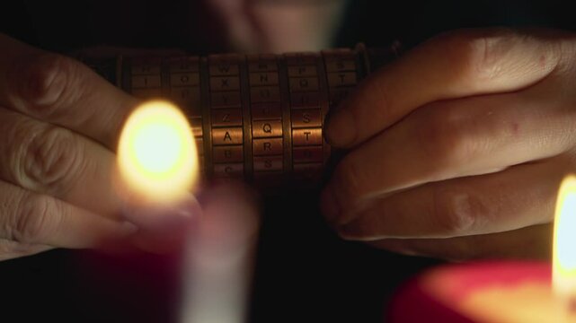 Mystery man in candlelit room solving secret cryptex code enigma CLOSE-UP