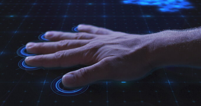 Image of man's hand touching interactive screen reading fingerprints and data processing