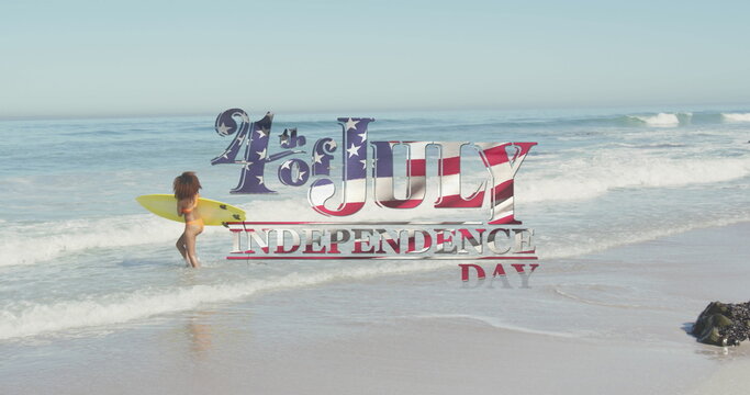 American flag waving over independence day text against woman with surfboard on the beach - Powered by Adobe
