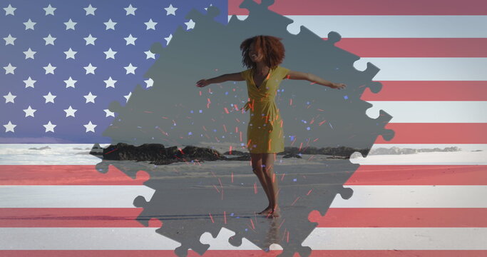 Image of american flag jigsaw puzzles revealing confetti and woman spinning on beach