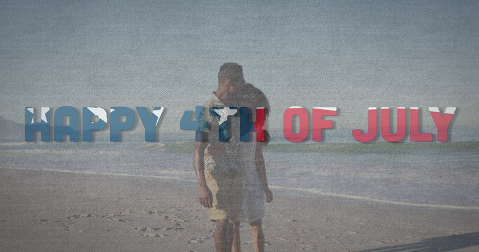 Image of happy 4th of july text with american flag pattern waving over couple in love on beach - Powered by Adobe