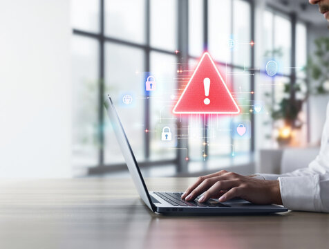 Person using laptop with cybersecurity warning alert icons floating in modern office. Digital concept of data protection, privacy, and online security. Ai generative