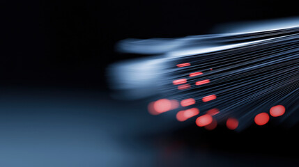 Fiber optic cables with glowing red tips on dark background