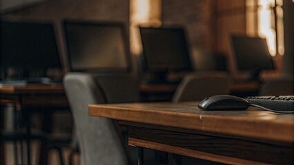 Empty office desk with vacant chairs and computers, symbolizing workforce layoffs and corporate downsizing, representing unemployment and economic challenges in modern workplace.