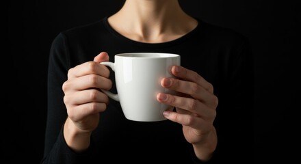 Hands holding a blank white coffee mug.