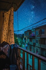 Friends wrap themselves in blankets as they eat suhoor on a balcony overlooking the quiet street. The stars shine brightly in the early morning sky
