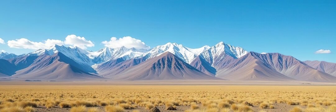 Majestic snow-capped mountains and vast rolling steppe under a clear blue sky in Kyrgyzstan, mountains,  stunning
