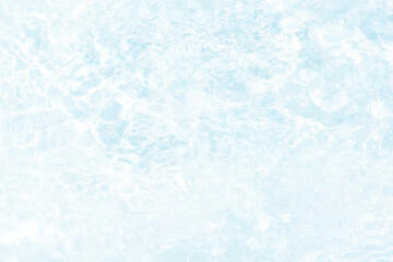 Blue water with ripples on the surface. Defocus blurred transparent blue colored clear calm water surface texture with splashes and bubbles. Water waves with shining pattern texture background.
