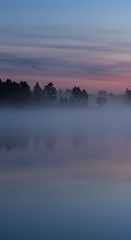 A tranquil mist-covered lake scene with soft, moody lighting and faint tree silhouettes in the background
