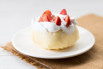 Crepe cake topped with fresh cream and strawberries.