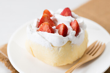 Crepe cake topped with fresh cream and strawberries.