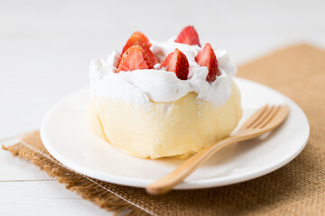 Crepe cake topped with fresh cream and strawberries.
