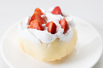 Crepe cake topped with fresh cream and strawberries.