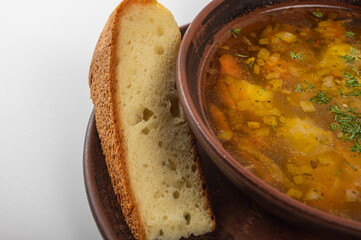 Traditional Ukrainian borscht in a rustic clay bowl, served with sour cream and fresh dill, accompanied by a slice of homemade bread. Classic Slavic cuisine and comfort food	