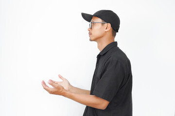 A man wearing a black shirt and a black hat is looking up at the camera