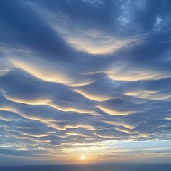 Serene Sunrise Over Rippled Cloudscape Displaying Soft Hues of Blue and Gold, Evoking Calm and Tranquility in Nature's Splendor at Dawn