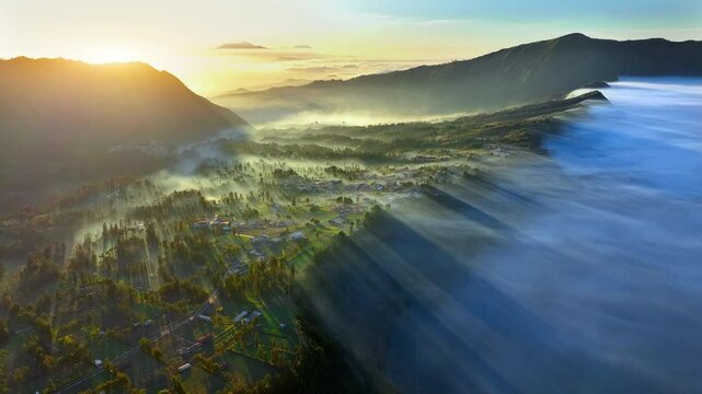 Aerial view flying to mount Bromo at sunrise, active volcano above sea of clouds, Java, Indonesia 
