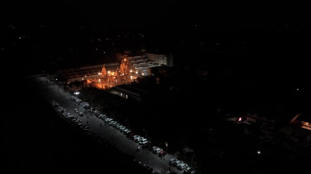 Aerial view of Hindu temple at night time with the dark background.