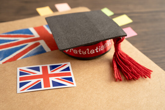 UK flag with graduate hat on english language book.