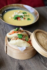 Gua Bao Buns with Pulled Meat and Fresh Vegetables in a Bamboo Steamer
