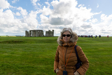 Senior tourist visiting stonehenge prehistoric monument in england