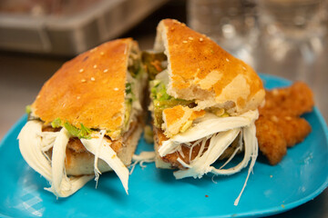 Cemita Poblana. A traditional Mexican sandwich with breaded pork and chipotle chili, quesillo cheese, and papalo leaves.