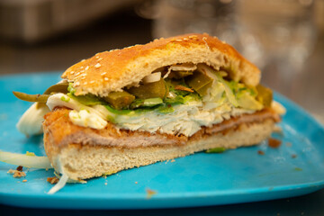Cemita Poblana. A traditional Mexican sandwich with breaded pork and chipotle chili, quesillo cheese, and papalo leaves.